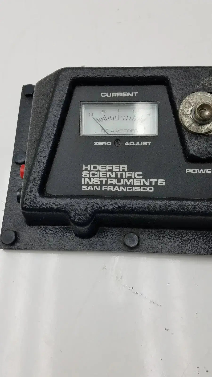 Black plastic current ammeter with silver dial and hoefer scientific instruments label for transphor power supply