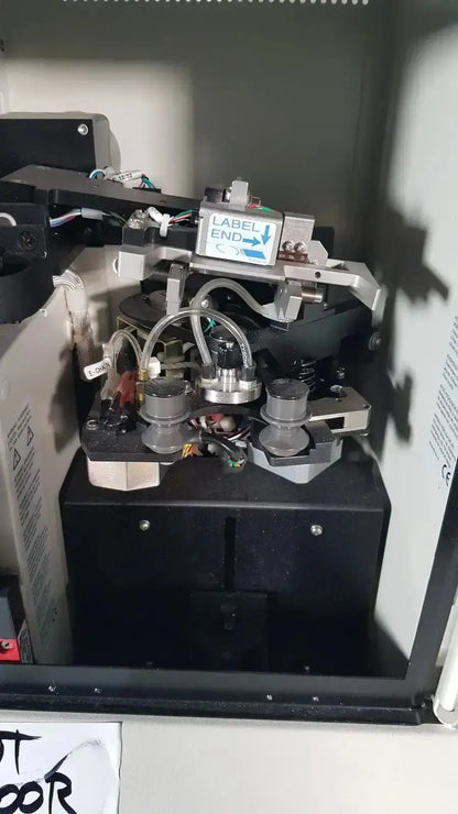 Black industrial label printer with metallic components and label end indicator for hologic thinprep biomedical evaluation