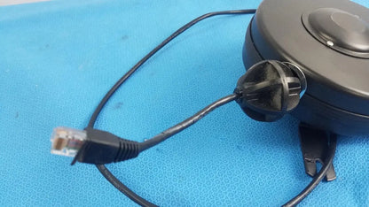 Black retractable cat5e cable with rj45 connector extending from hospital grade cable reel for medical equipment use