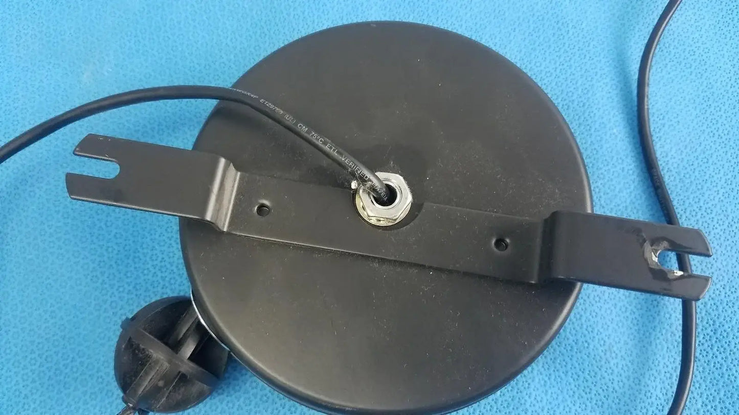 Black circular ceiling light fixture with metal bracket and wiring for hospital medical equipment retractable cat5e cable reel