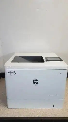 White HP LaserJet Enterprise M555dn color laser printer with a sleek rectangular design and touchscreen display on top right