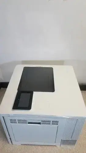 Light gray hp laser printer with black flatbed scanner and tablet on top hp laserjet enterprise m555dn color model