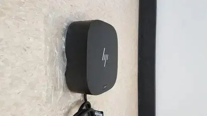 Black hp wireless charging pad with matte finish and rounded rectangular design for single cable alt mode 65w power delivery