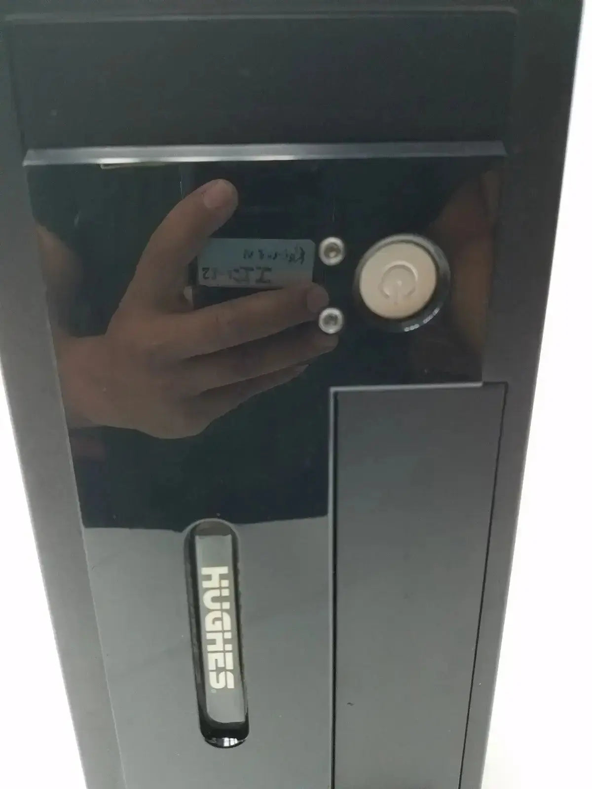 Black hughes network security doorbell model mgs3550 with circular button and three silver screws on reflective surface hospital surplus