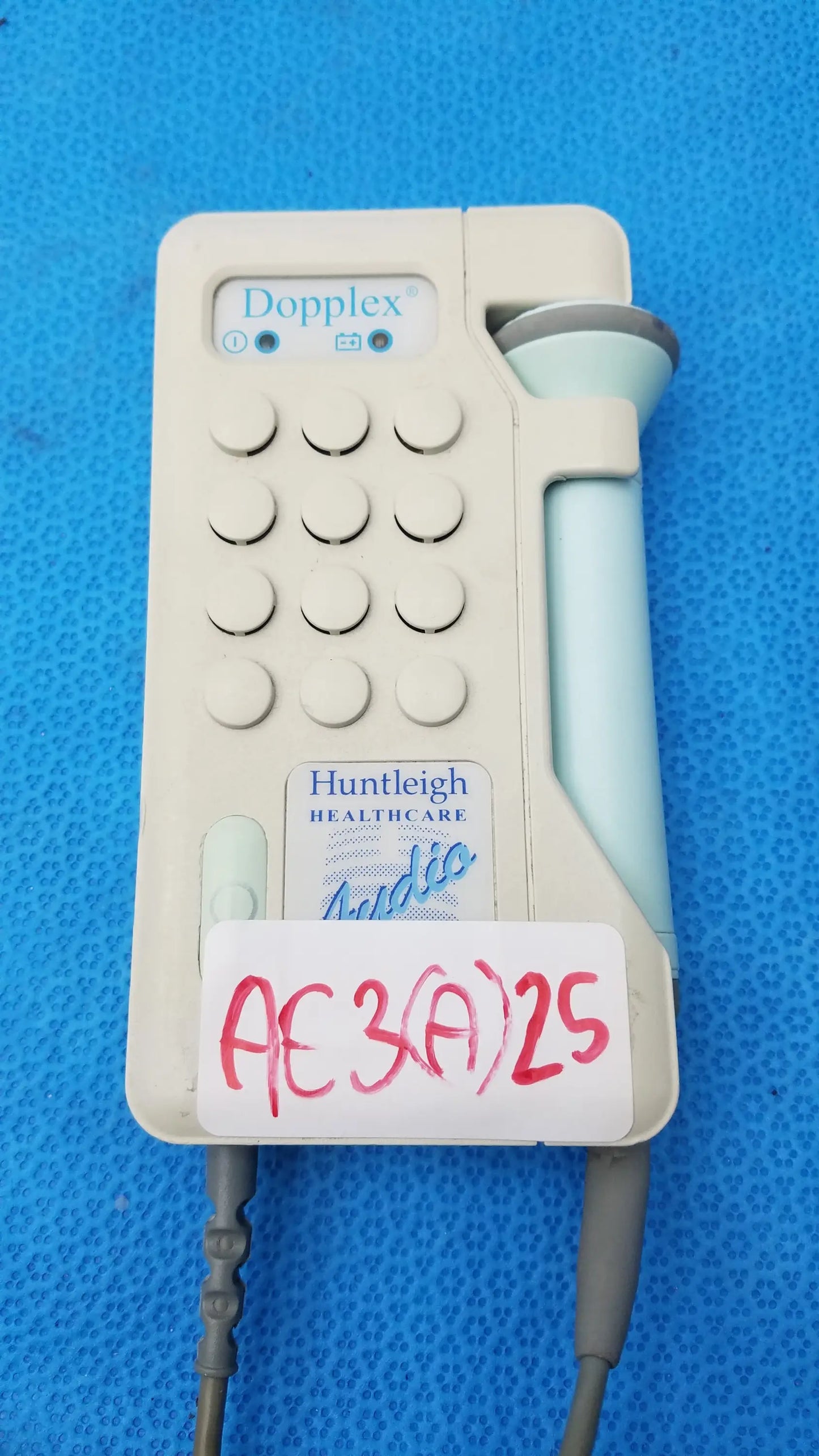 Beige plastic huntleigh healthcare dopplex d920 handheld doppler medical equipment with light blue transducer probe