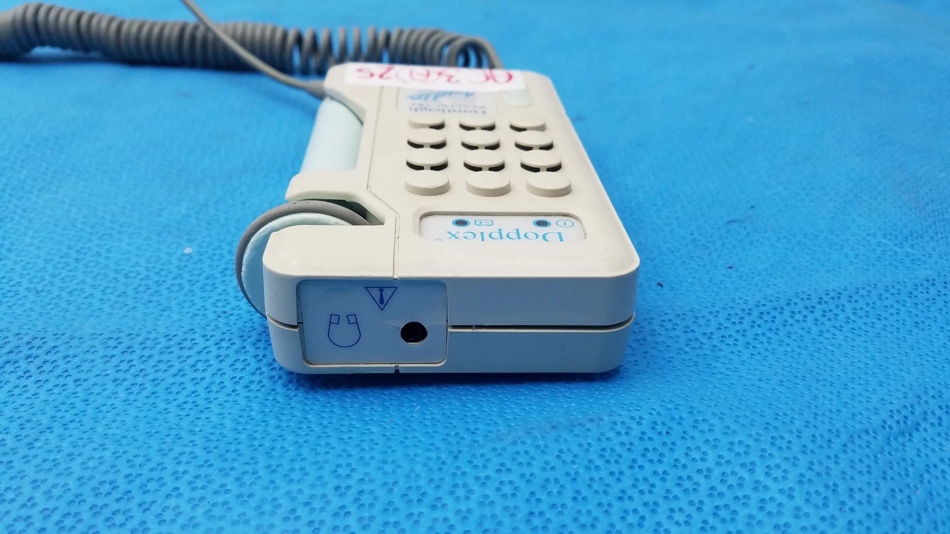 Beige huntleigh dopplex d920 handheld doppler medical monitor with numeric keypad and coiled cord for precise diagnostics