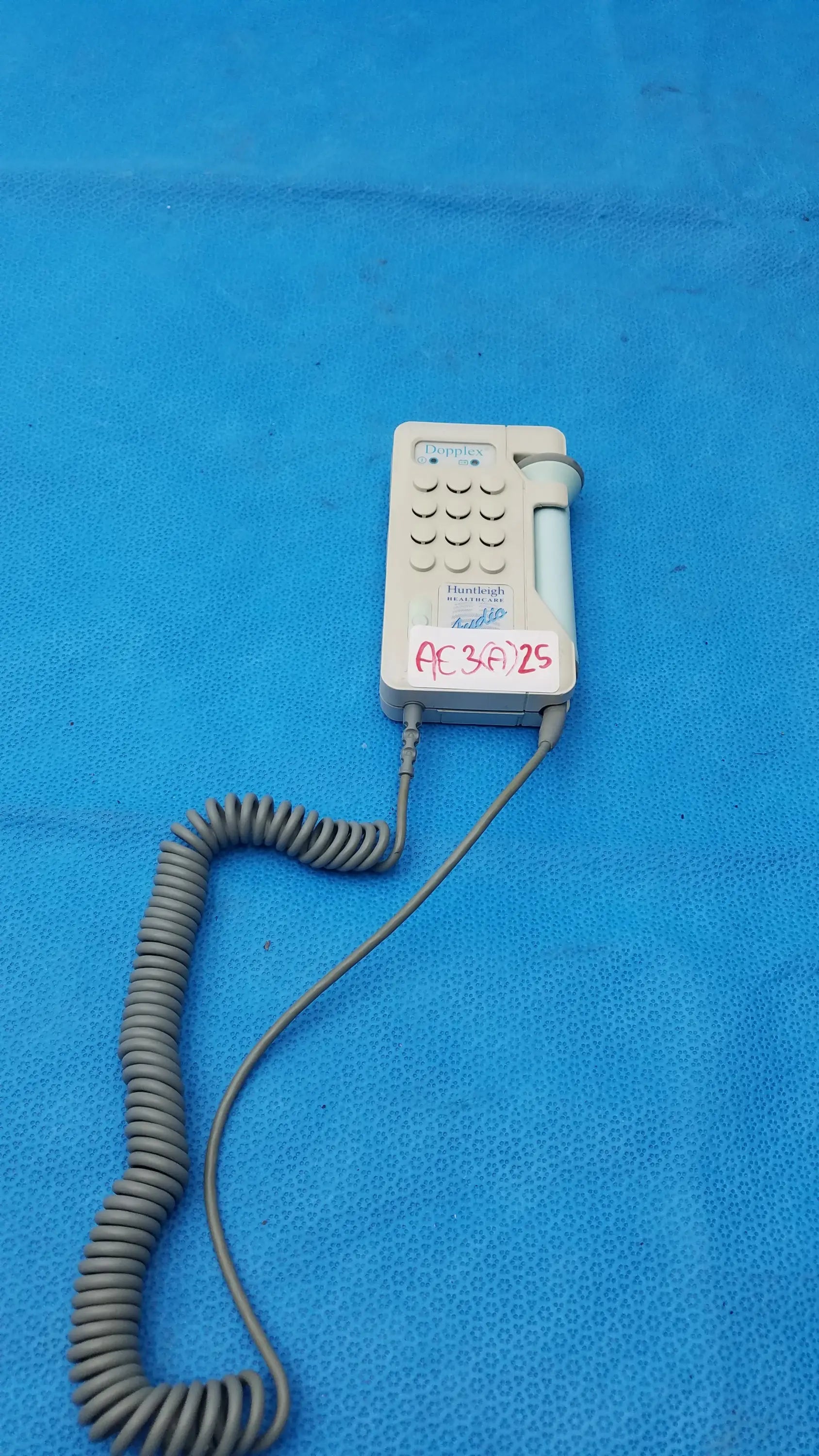 Beige plastic medical call button with coiled gray cord and keypad for huntleigh dopplex d920 handheld doppler medical equipment