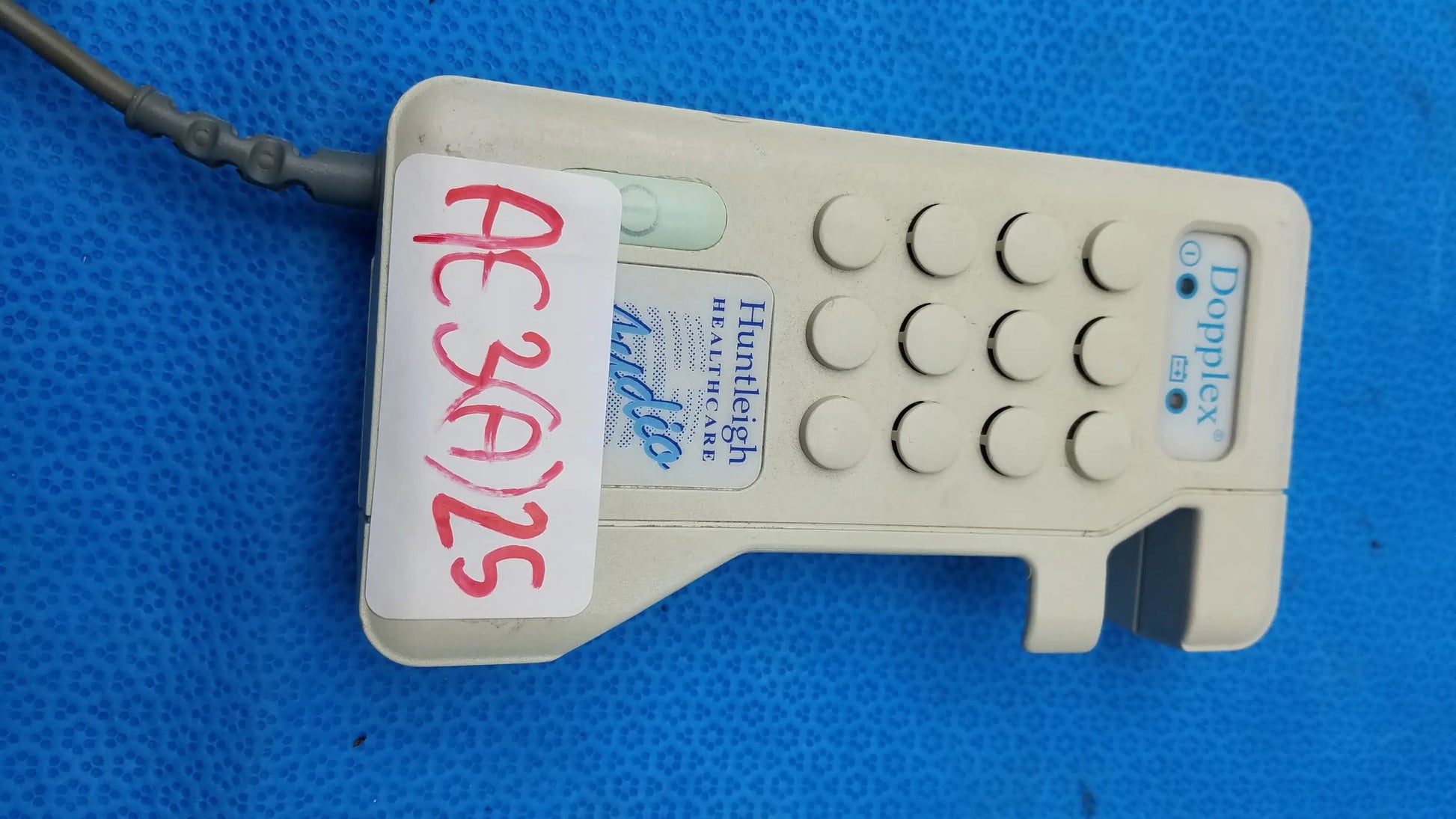 Beige plastic huntleigh dopplex d920 handheld doppler medical equipment with keypad and attached probe cable by smiths medical