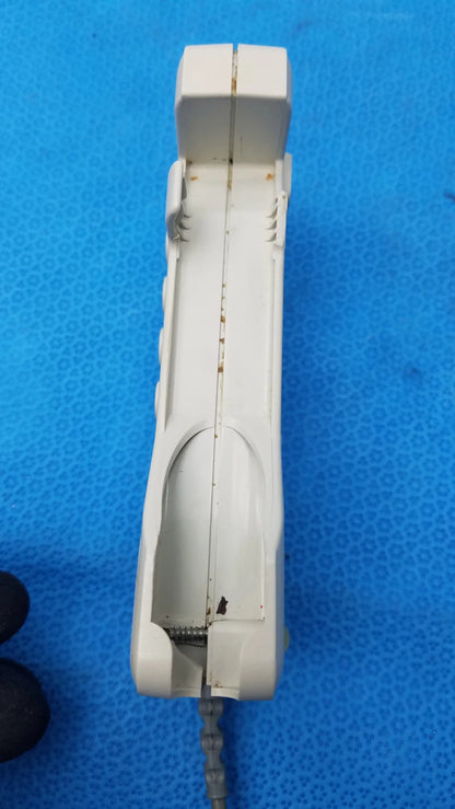 White plastic cordless phone with rust and wear edges used with huntleigh dopplex d920 handheld doppler medical equipment