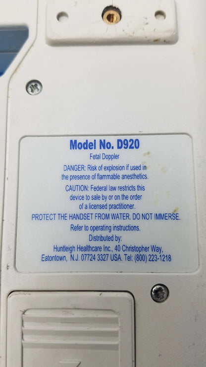 White plastic handheld fetal doppler medical equipment with blue label model d920 safety warnings smiths medical