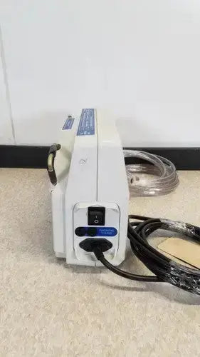 White medical infusion huntleigh vp5000 dvt pump with blue accents and coiled black power cord for therapy use