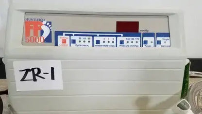 White plastic Huntleigh VP5000 DVT pump with digital display, blue and red buttons, and zr-1 label on front