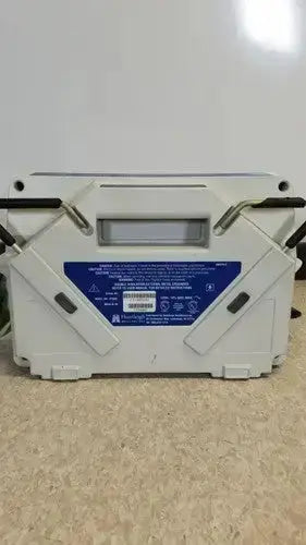 White plastic tool case with black handle grips and blue label on the back of huntleigh vp5000 dvt pump