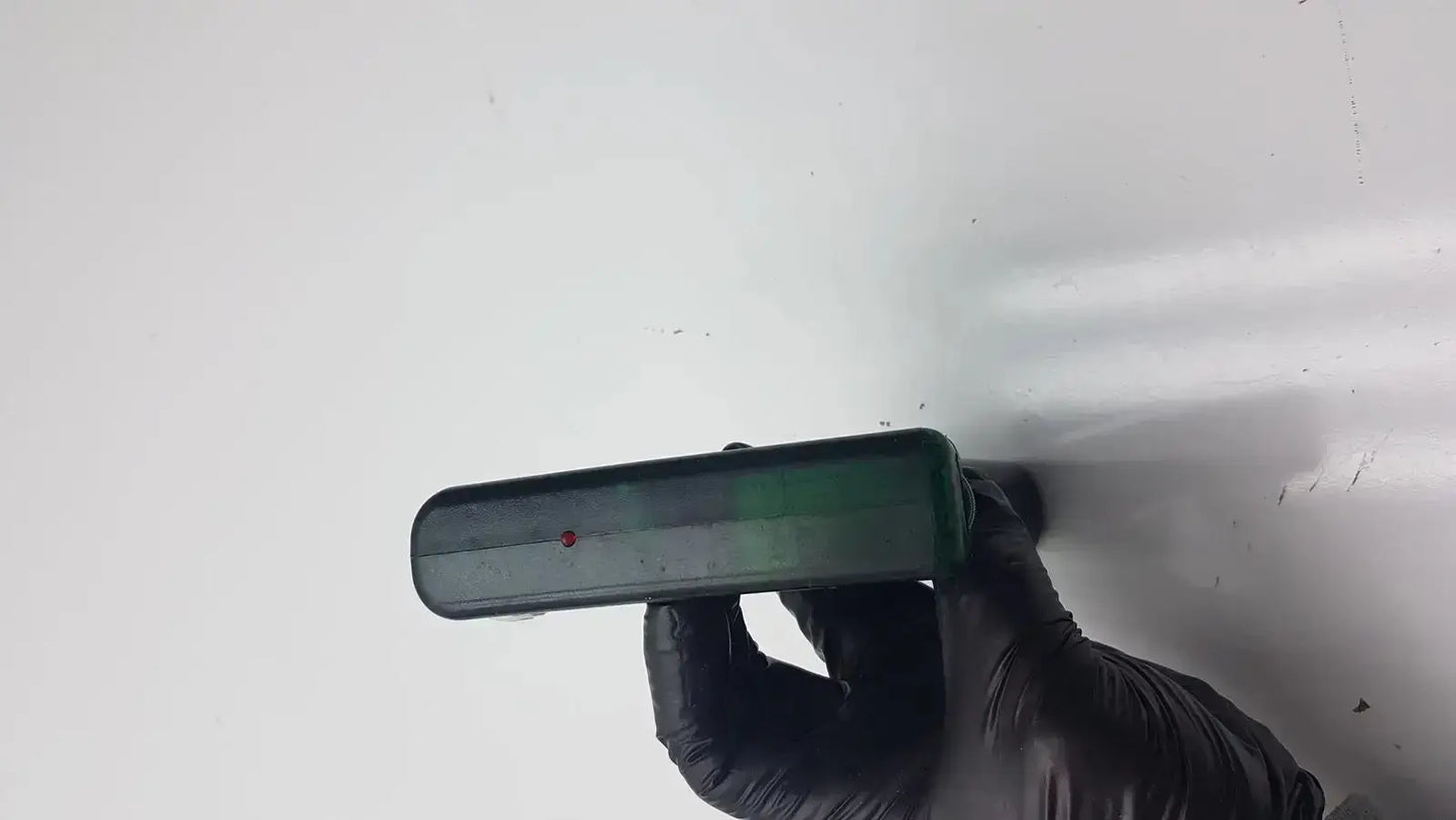 Dark green integra biosciences acu biosciences acu pipetboy controller held by black-gloved hands with red dot feature
