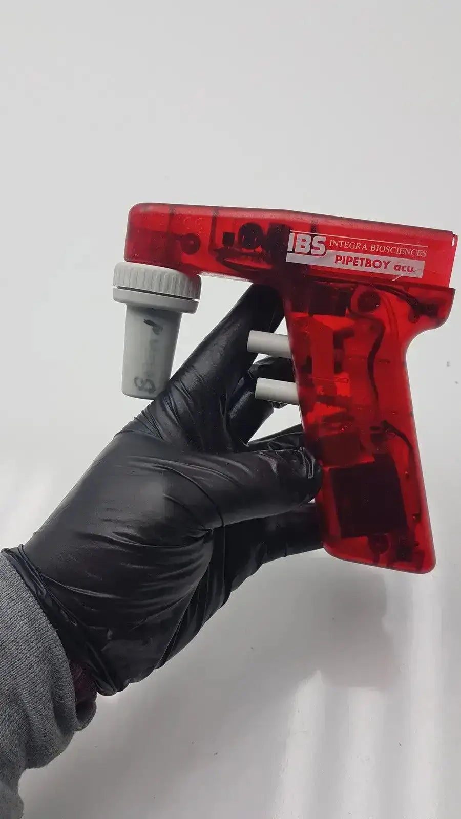 Red translucent plastic handheld pipette with gray accents and white labeling for integra biosciences acu pipetboy controller