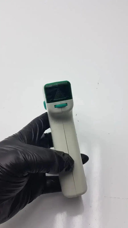 Handheld non-contact infrared thermometer with white body green accents and digital display in integra biosciences acu pipetboy controller