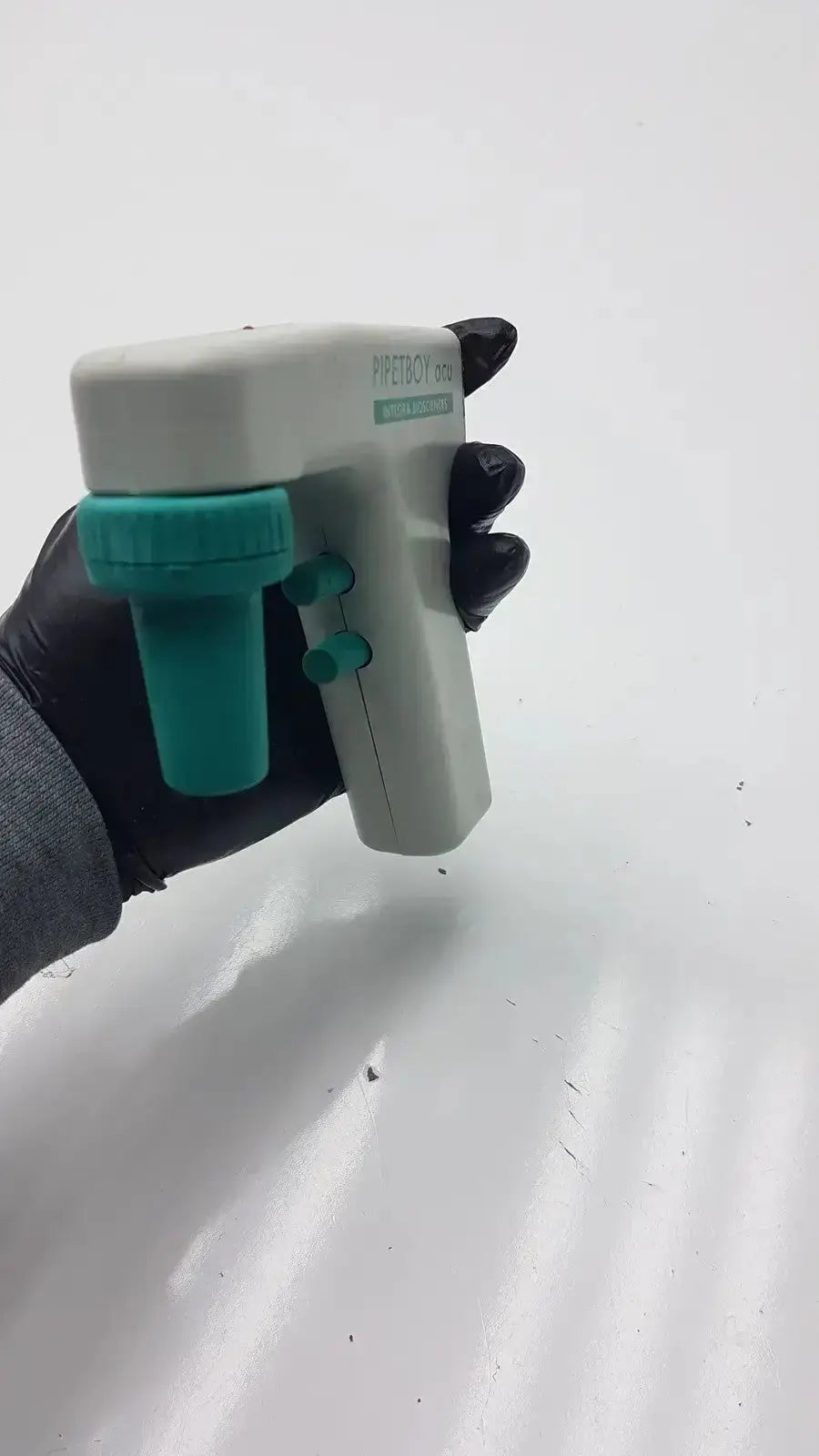 Integra biosciences acu pipetboy controller handheld device in white and teal with textured grip and papetoc branding