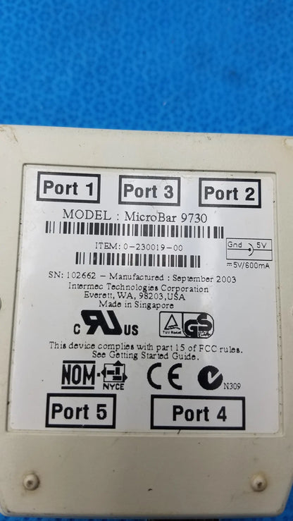 White plastic intermec microbar 9730 decoder wedge with five ports and regulatory markings for reuse medical equipment