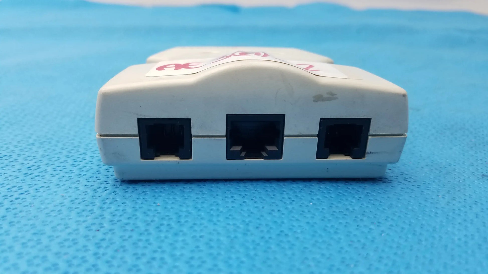 White plastic intermec microbar 9730 decoder wedge with three black rj45 ports for reuse medical equipment connectivity
