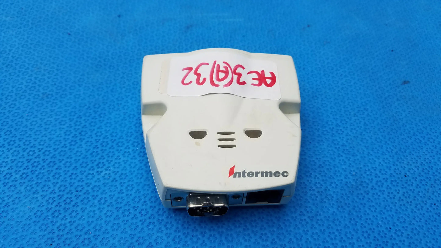 White plastic intermec microbar 9730 decoder wedge with red handwritten label and two side ports for reuse medical equipment