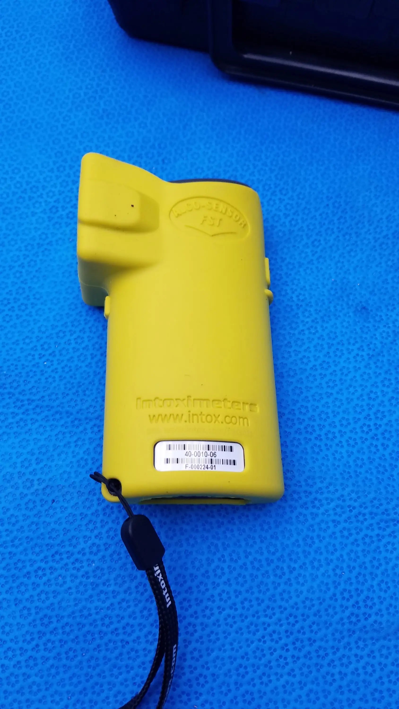 Yellow plastic intoximeters alco-sensor fst portable breathalyzer with black lanyard used in medical equipment by smiths medical