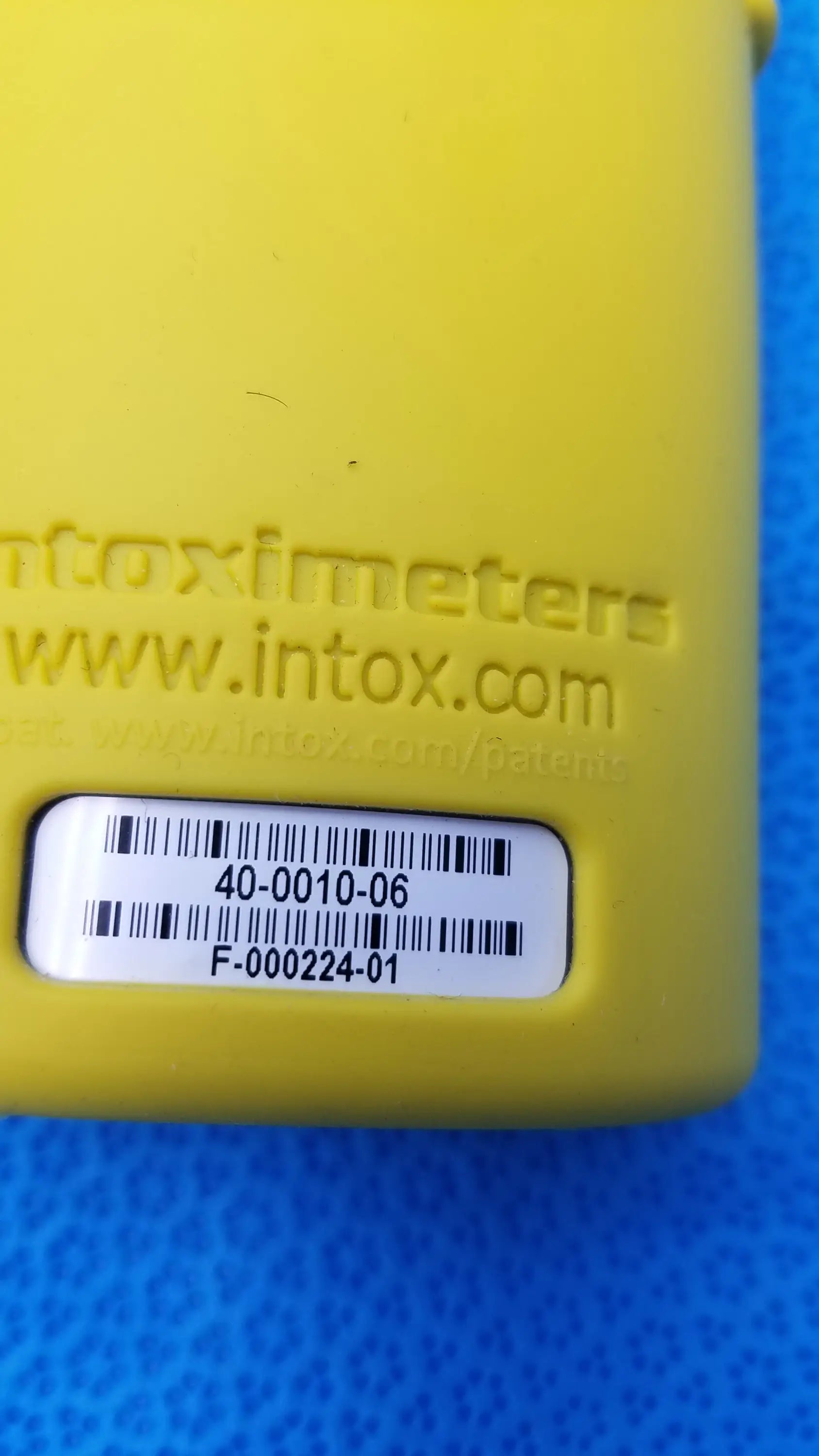 Yellow intoximeters alco-sensor fst portable breathalyzer device with embossed branding and white barcode label medical equipment