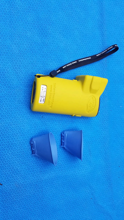 Yellow plastic pepper spray device with black wrist strap and two blue caps alongside intoximeters alco-sensor fst medical equipment case
