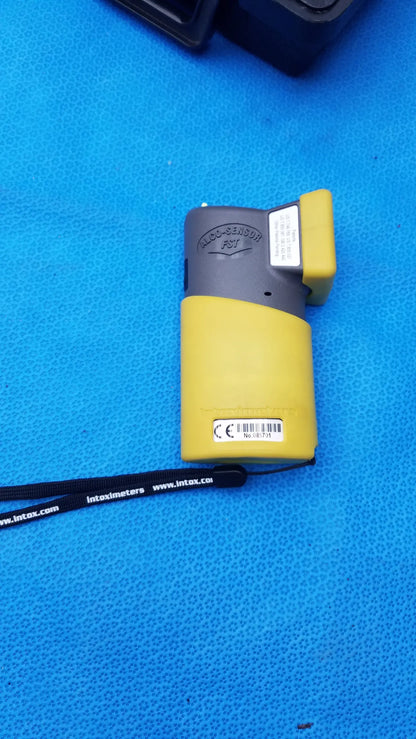 Yellow and gray intoximeter p37 portable handheld breathalyzer with black wrist strap medical equipment by smiths medical