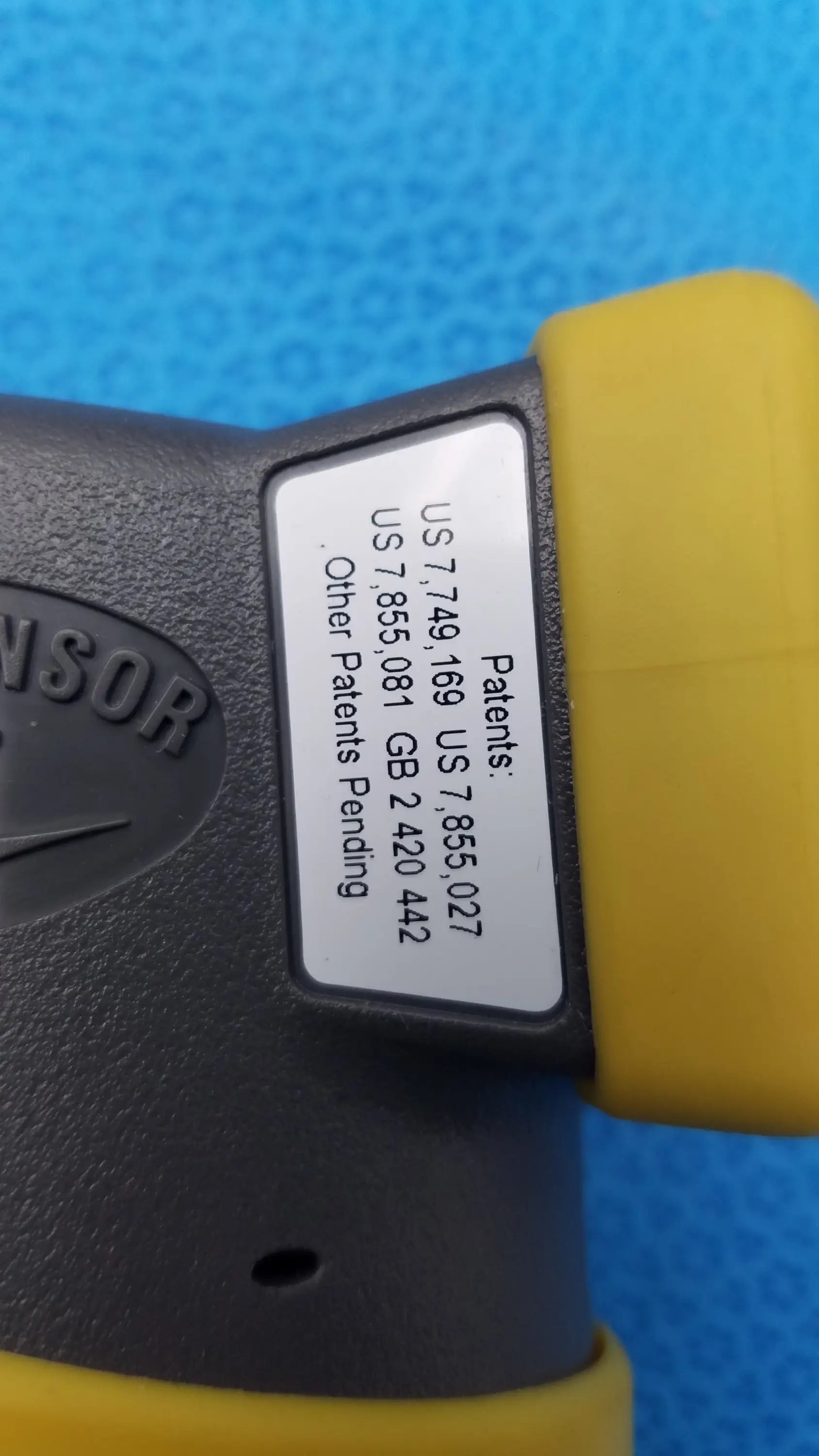 Yellow and gray intoximeters alco-sensor fst portable handheld breathalyzer with white label showing patent numbers medical equipment