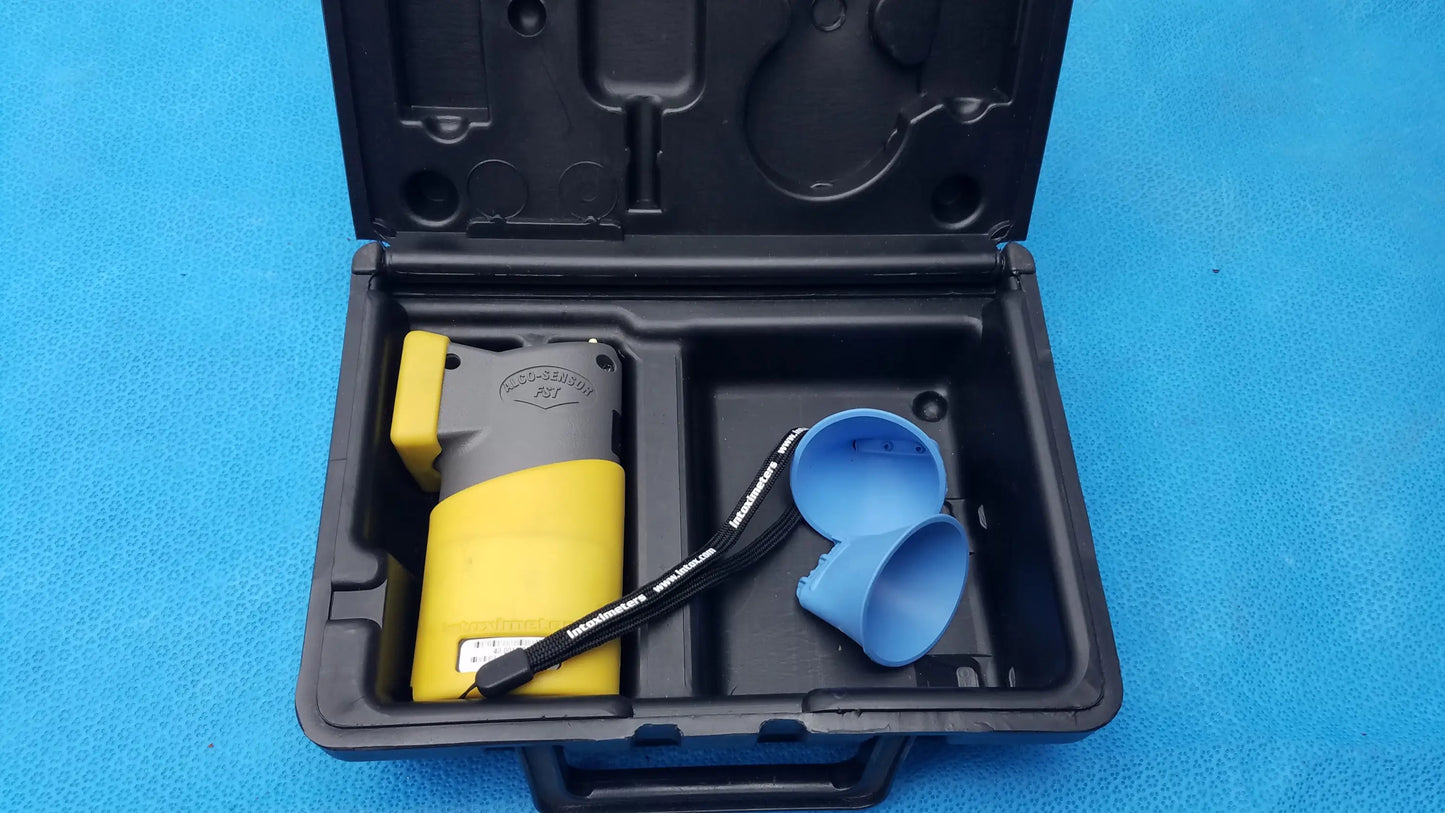 Yellow and gray portable handheld intoximeters alco-sensor fst breathalyzer with black strap in molded case medical equipment