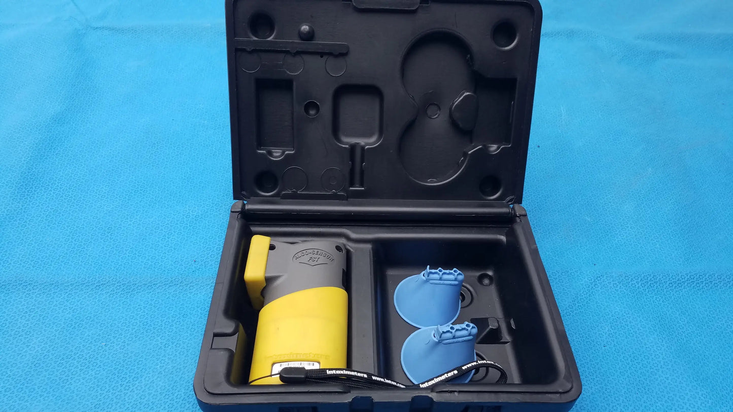 Yellow and gray pepper spray canister in black molded case for portable handheld use with intoximeters alco-sensor fst medical equipment