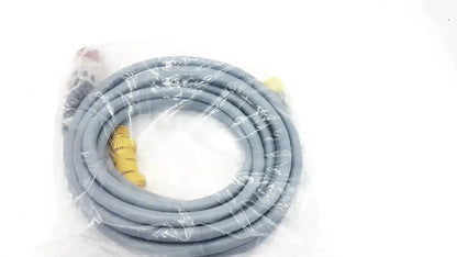 Gray coiled intuitive surgical davinci camera connecting cable with yellow connectors wrapped in clear plastic packaging