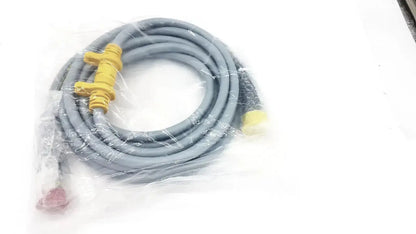 Intuitive Surgical DaVinci gray coiled camera connecting cable with yellow connectors and red plug in clear plastic packaging