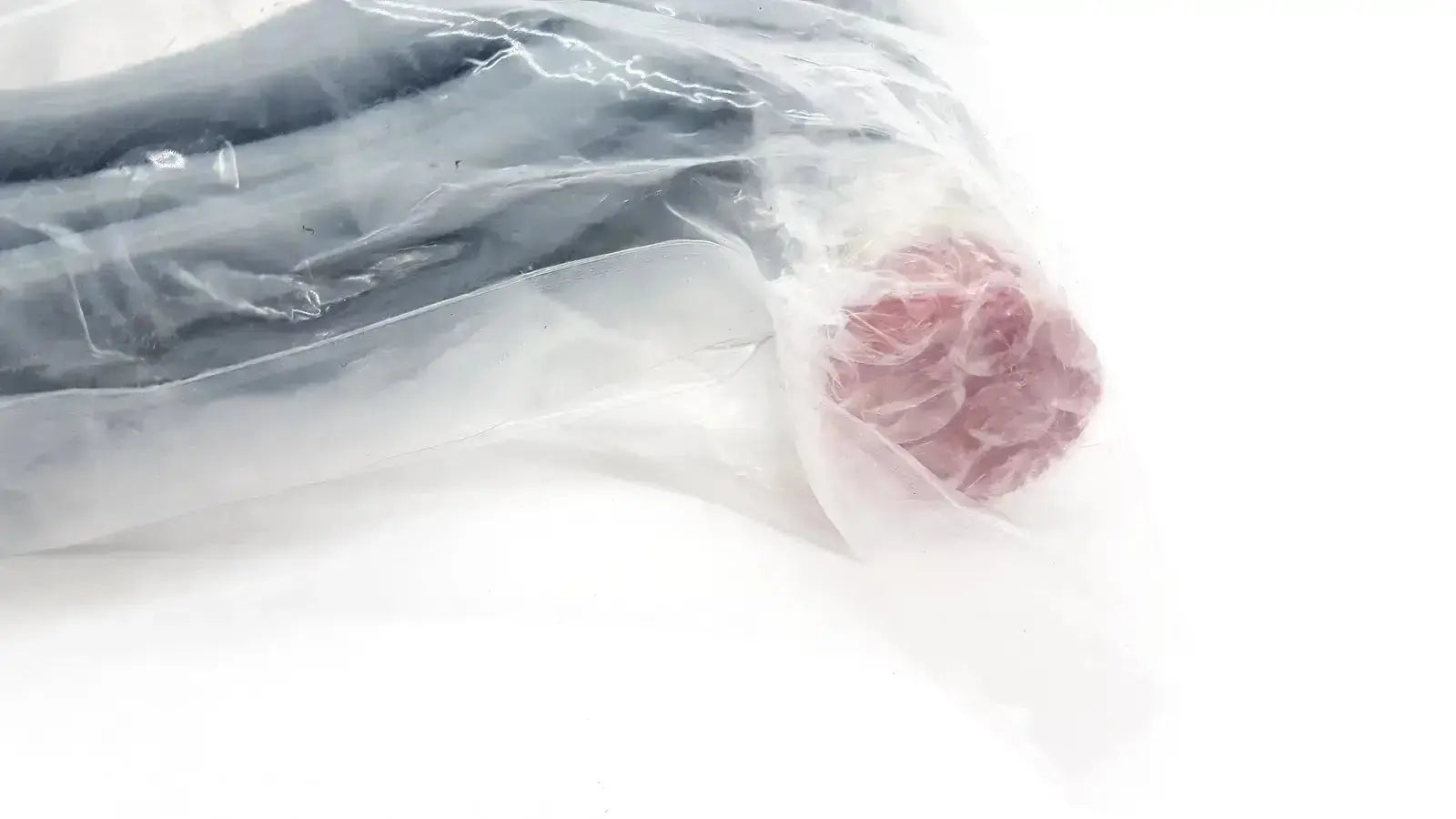 Vacuum-sealed bag containing intuitive surgical davinci camera connecting cable with pinkish-red textured end