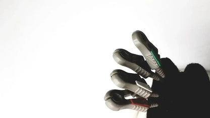 Gray and black robotic hand with textured grip surfaces and colored accents holding invivo 9240a ecg lead wires