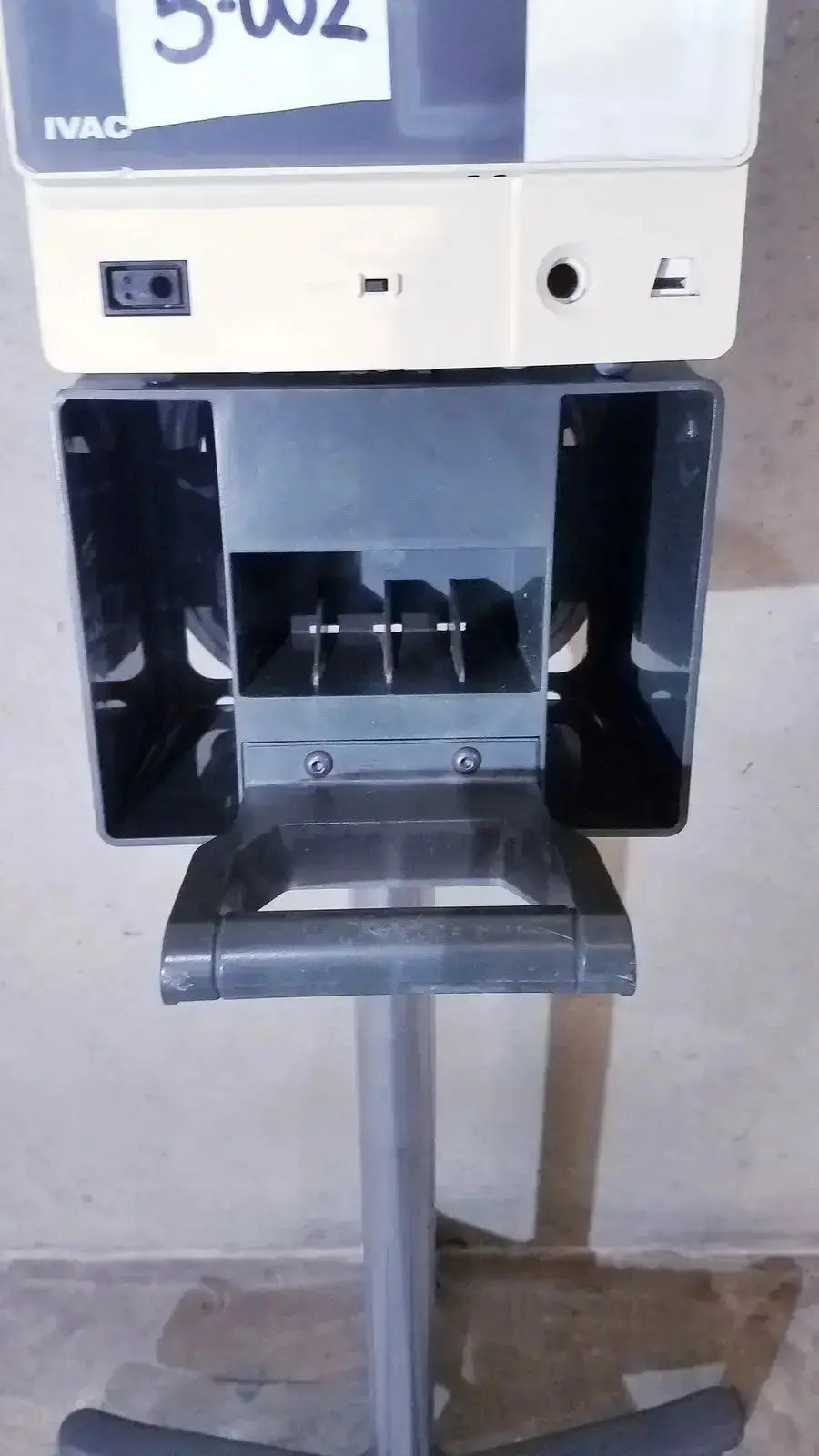 Ivac corporation vital check 4200 medical device in white and gray with labeled paper slot mounted on metal stand