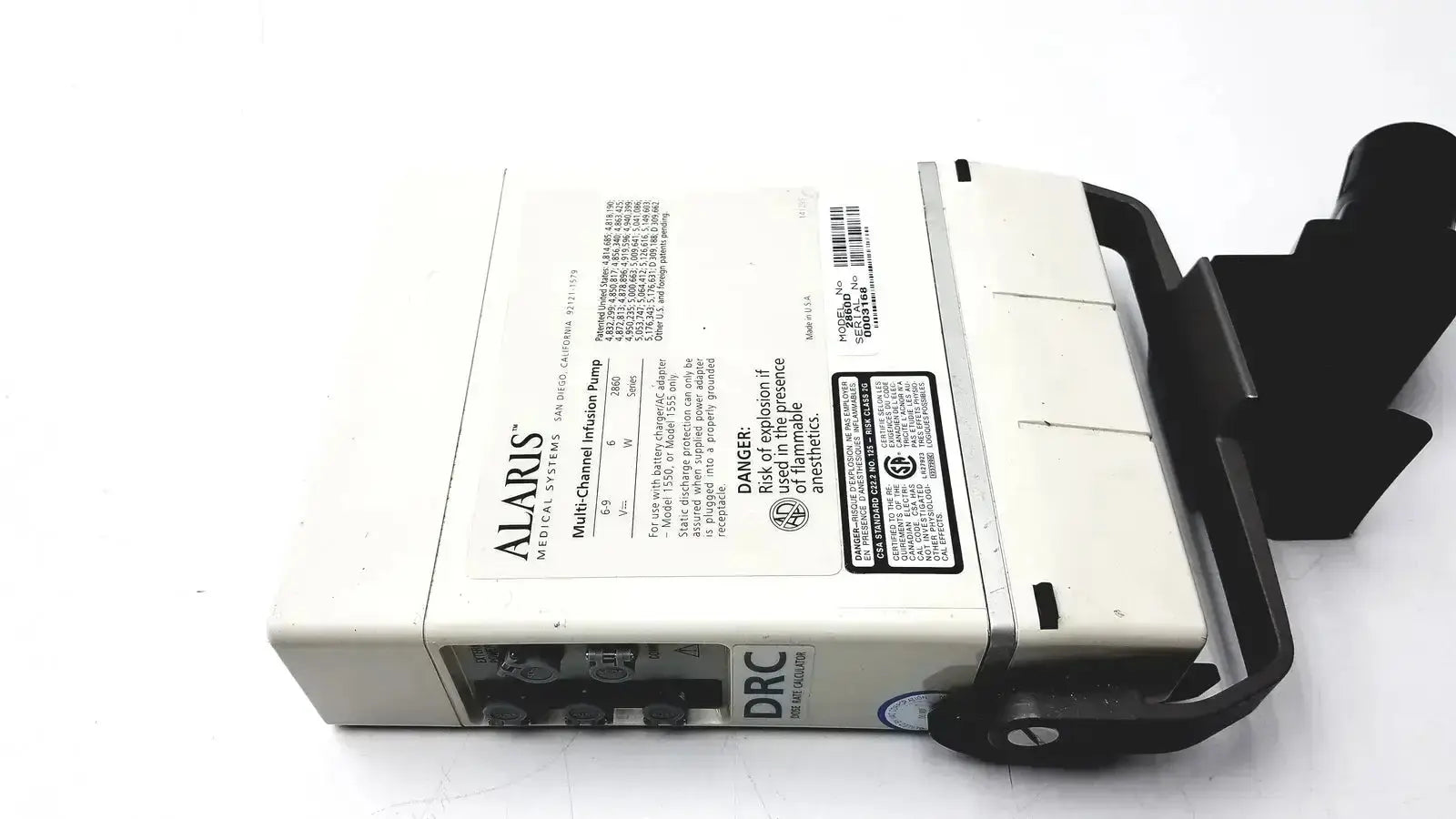 White alaris multi-channel infusion pump with black handle and side-mounted safety latch in ivac medsystem iii patient monitor 2860d