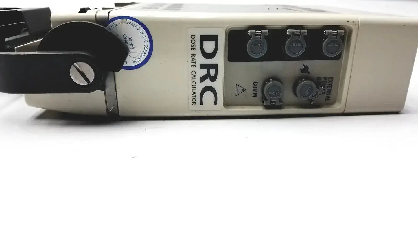 Beige plastic drc dose rate calculator with black rotary dial and multiple circular ports on alaris ivac medsystem iii patient monitor 2860d back side