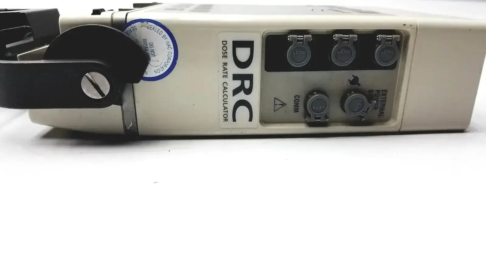 Beige plastic drc dose rate calculator with black rotary dial and multiple circular ports on alaris ivac medsystem iii patient monitor 2860d back side