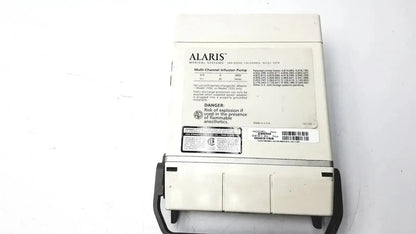 White alaris multi-channel infusion pump with black tubing and model 60u478b label connected to patient monitor 2860d medsystem iii