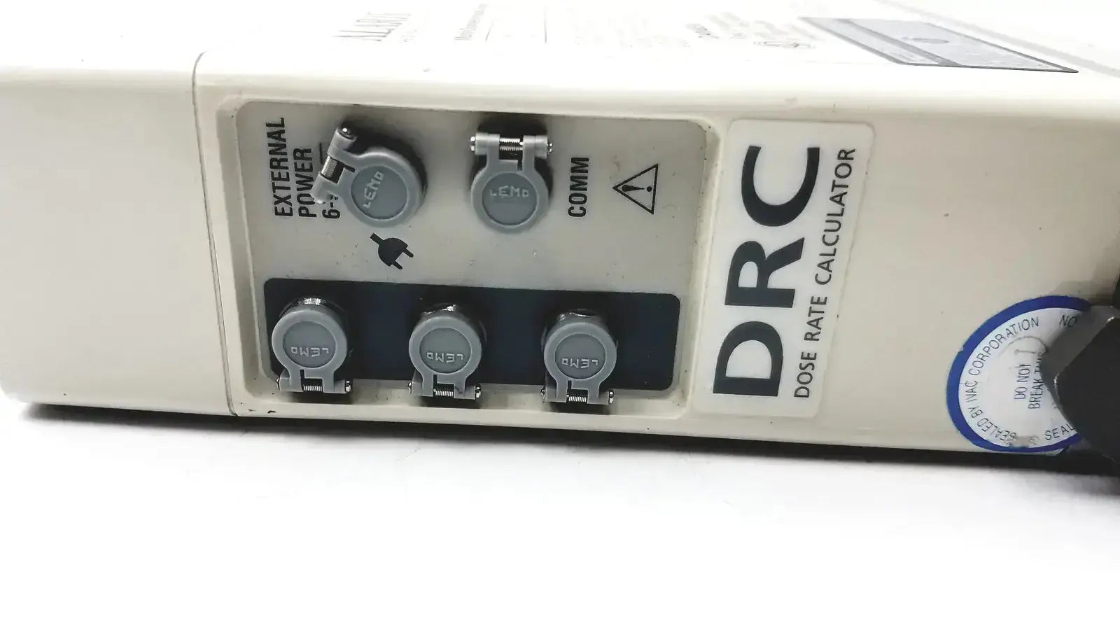 White plastic drc dose rate calculator with gray connectors and blue sticker on the back of patient monitor 2860d medsystem iii