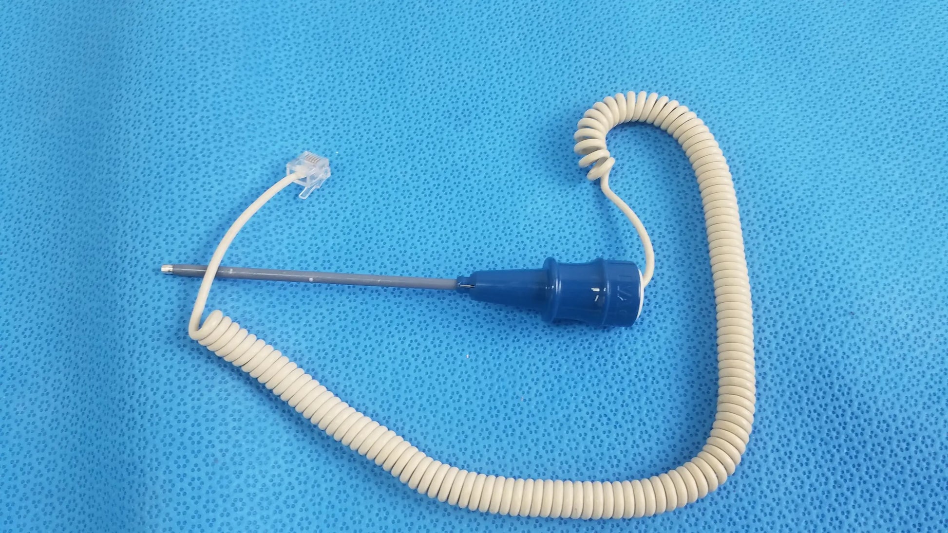 Ivac turbotemp oral temperature probe with blue coating and coiled beige cable for reuse medical equipment care
