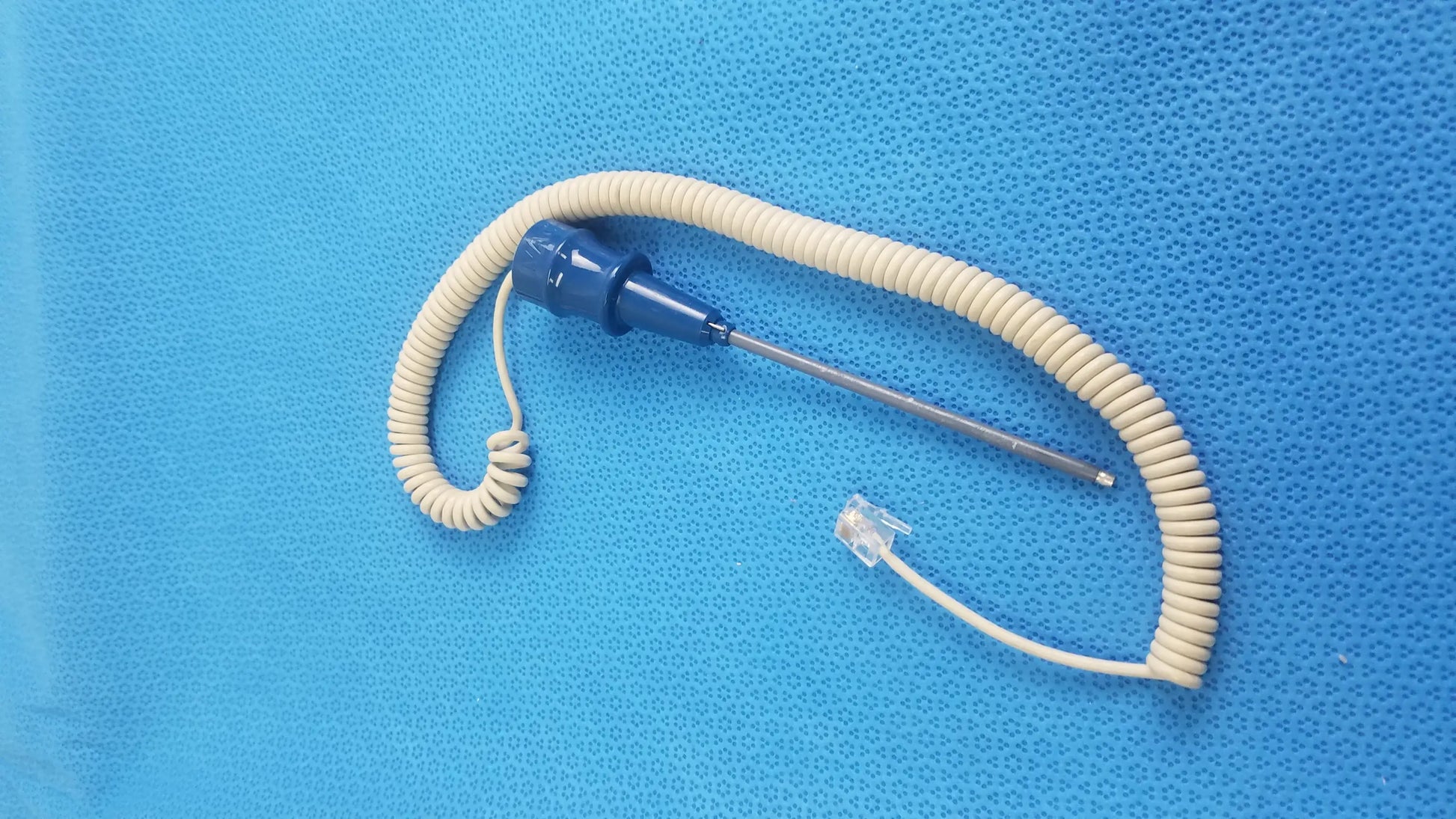 Blue ivac turbotemp oral temperature probe with coiled beige cable and metallic tip for reuse medical equipment use