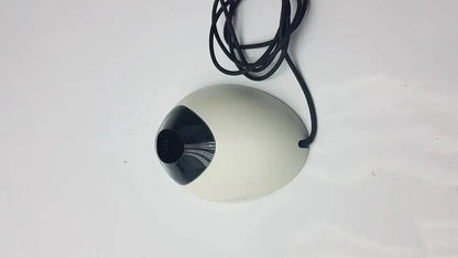 Off-white egg-shaped webcam with black lens and cable attached to ivoclar vivadent bluephase g2 docking stand