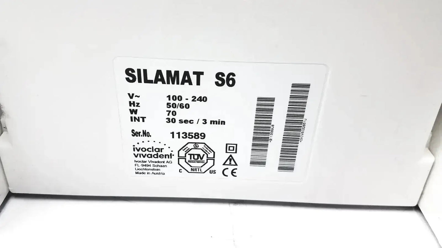 White rectangular label with black text and barcode on ivoclar vivadent silamat s6 amalgamator unit