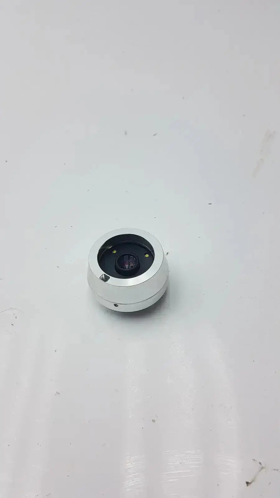 Silver cylindrical horus dental lens with black aperture and metallic housing for jedmed horus dental dtc use