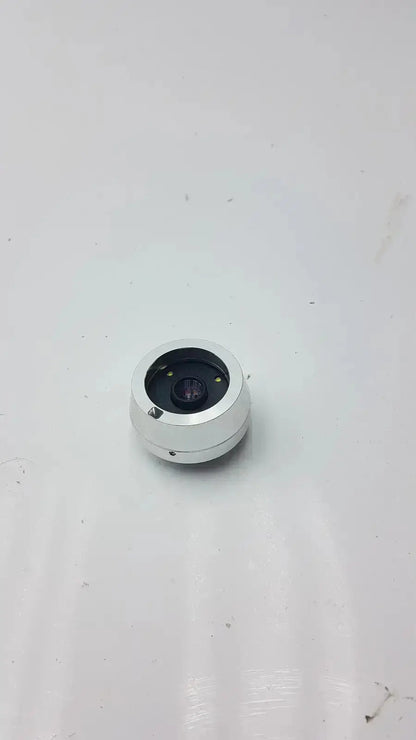 Silver cylindrical horus dental lens with black aperture and metallic housing for jedmed horus dental dtc use