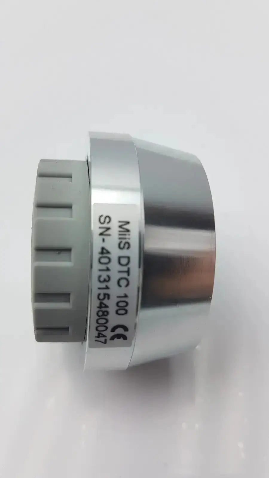 Silver metallic cylindrical jedmed horus dental lens dtc 100 with gray knob and white model label for dental use