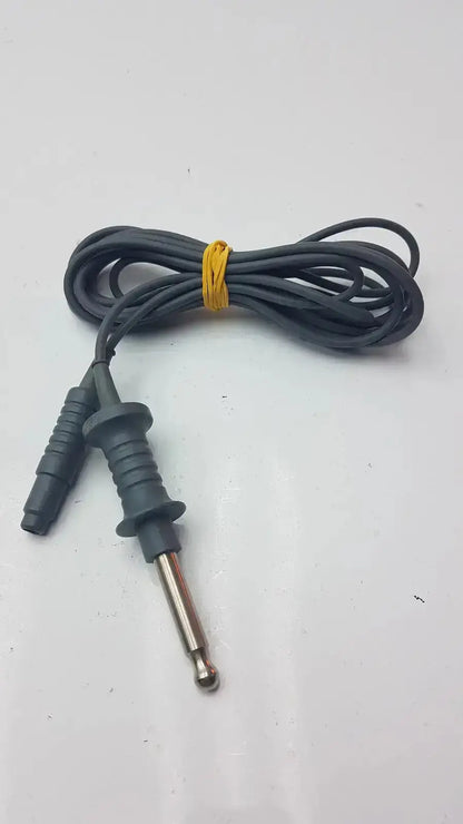 Black coiled karl storz 26006 m high-frequency unipolar cord with metallic tip and black plastic connector housing