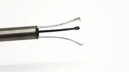 Metallic karl storz 27094p optical kidney stone grasper with sleek cylindrical handle and two fine curved wire loops